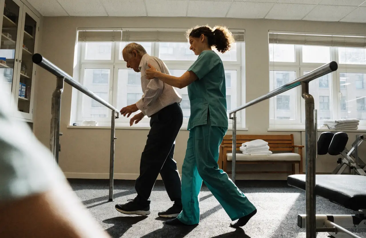 A therapist supporting a patient during a rehabilitation session